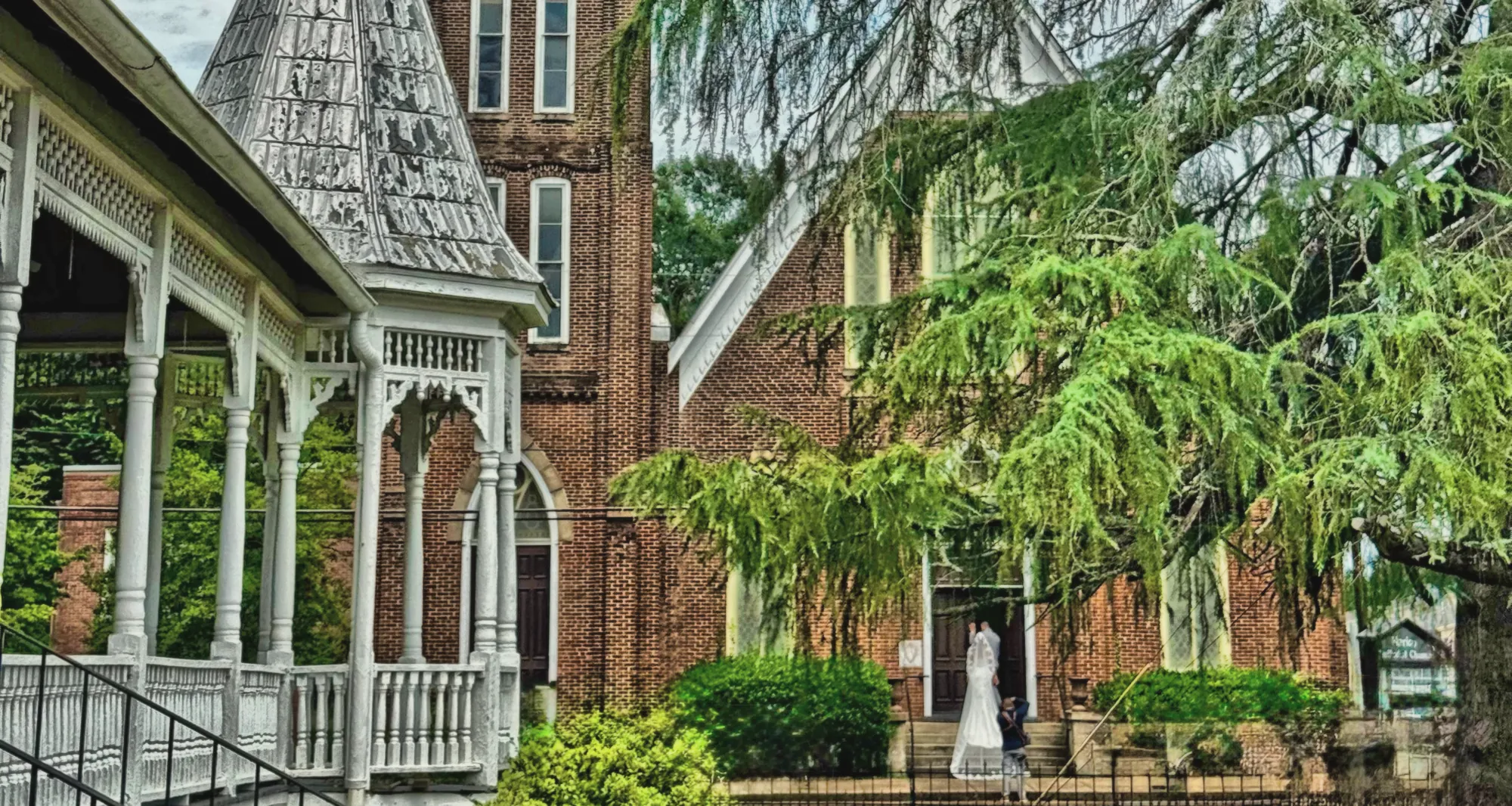 A bride on the steps of Marion Methodist Church beside VanCleave Hall's gingerbread porch and turret