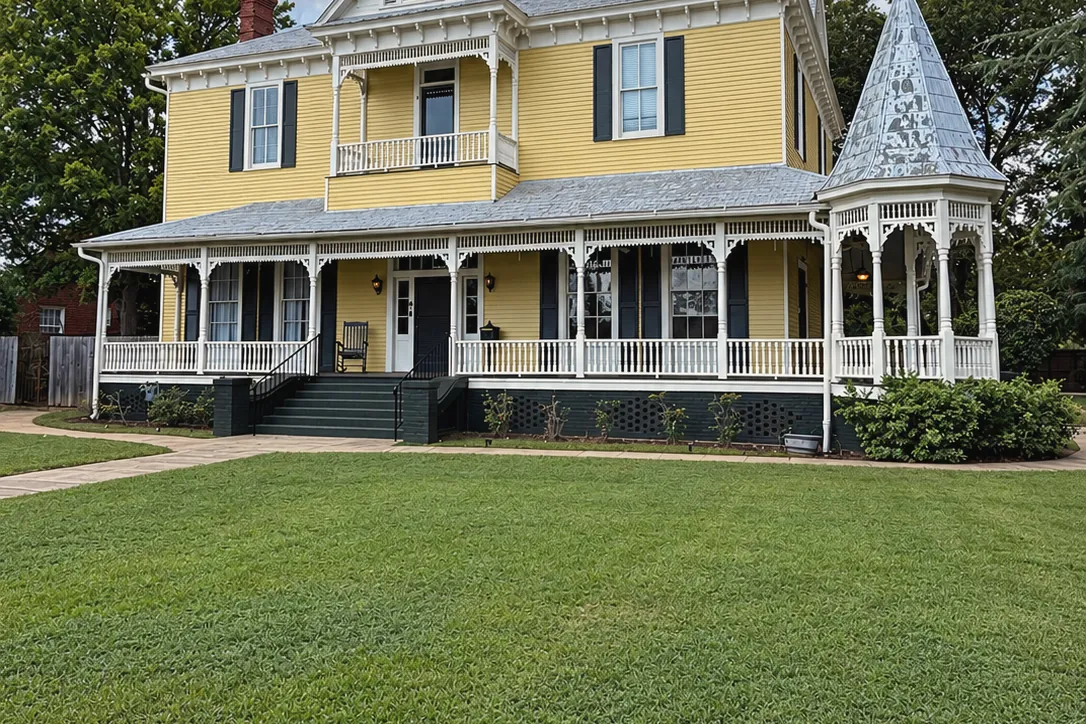 The wide front lawn before the house and its wraparound porch, where the rose garden is being planted